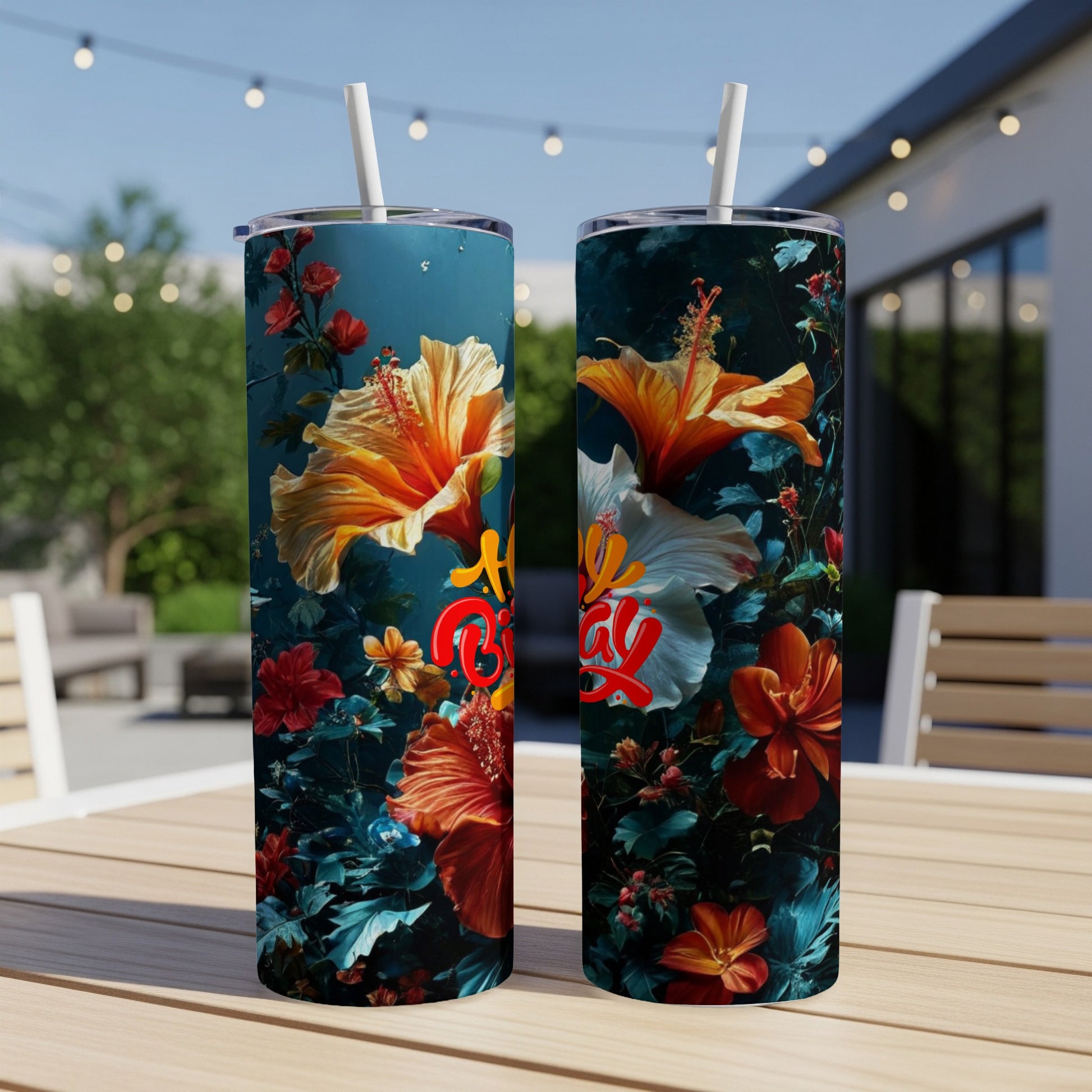 Two tall tumblers with vibrant floral patterns and "Blessed" text.