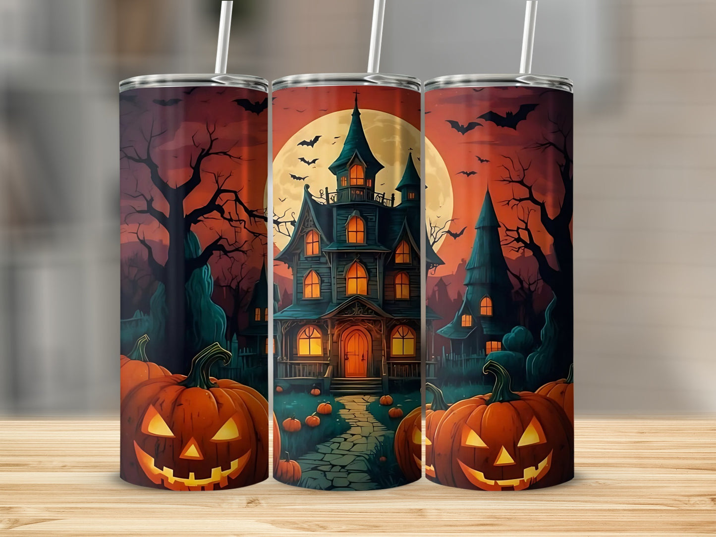 Three tumblers with a Halloween scene of a haunted house, jack-o'-lanterns, and bats.