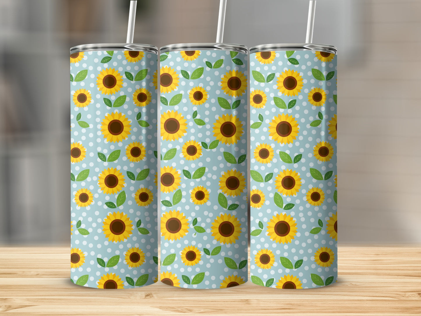 Three tumblers with a blue background, white polka dots, and yellow sunflowers and green leaves.
