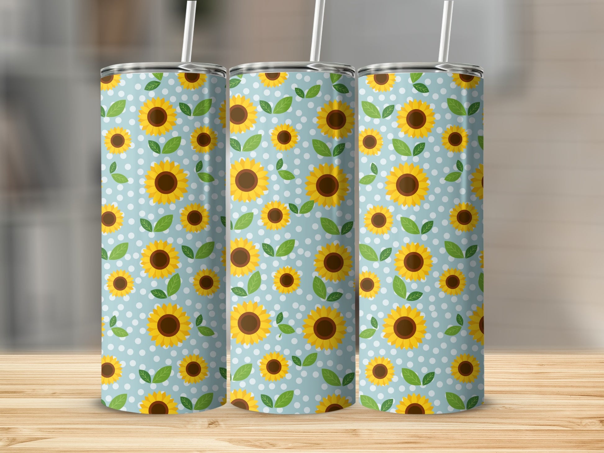 Three tumblers with a blue background, white polka dots, and yellow sunflowers and green leaves.