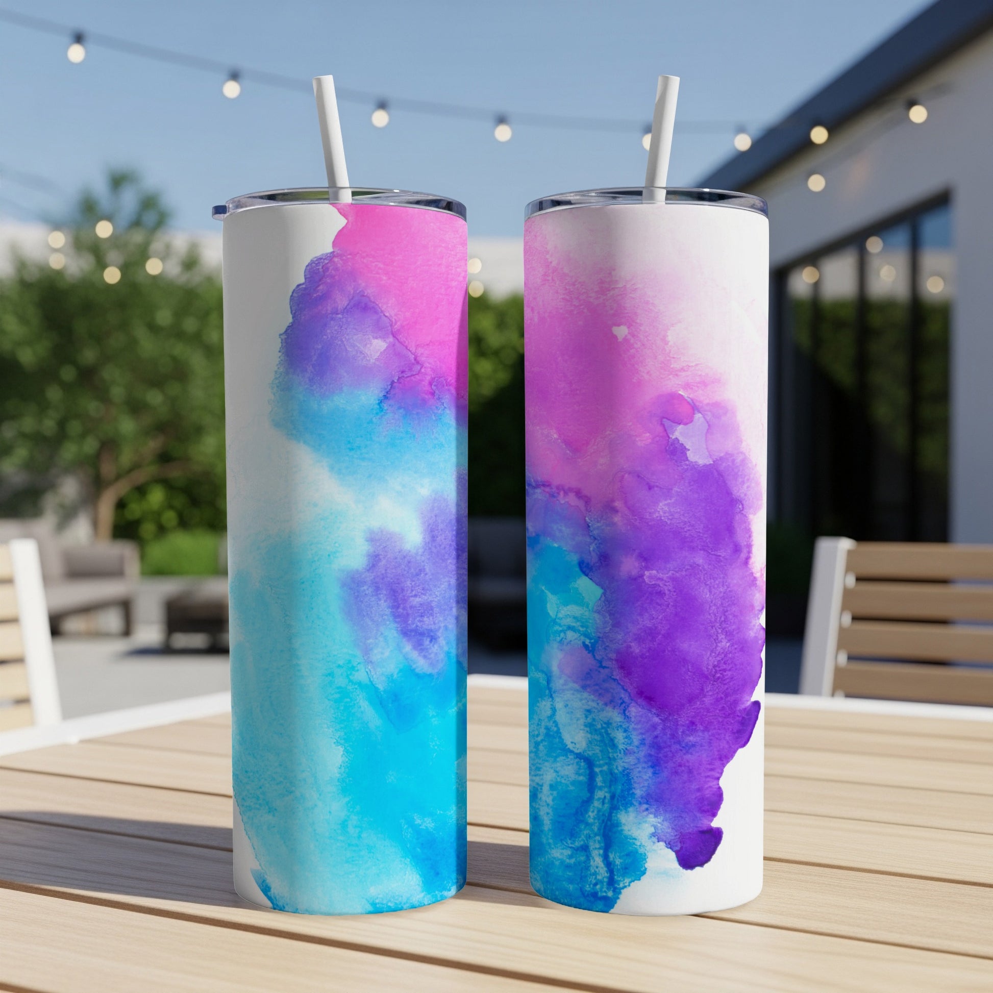 Two tall tumblers with watercolor designs of pink, blue, and purple.