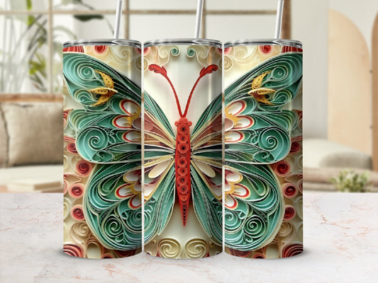 Quilled paper butterfly design on a tumbler.