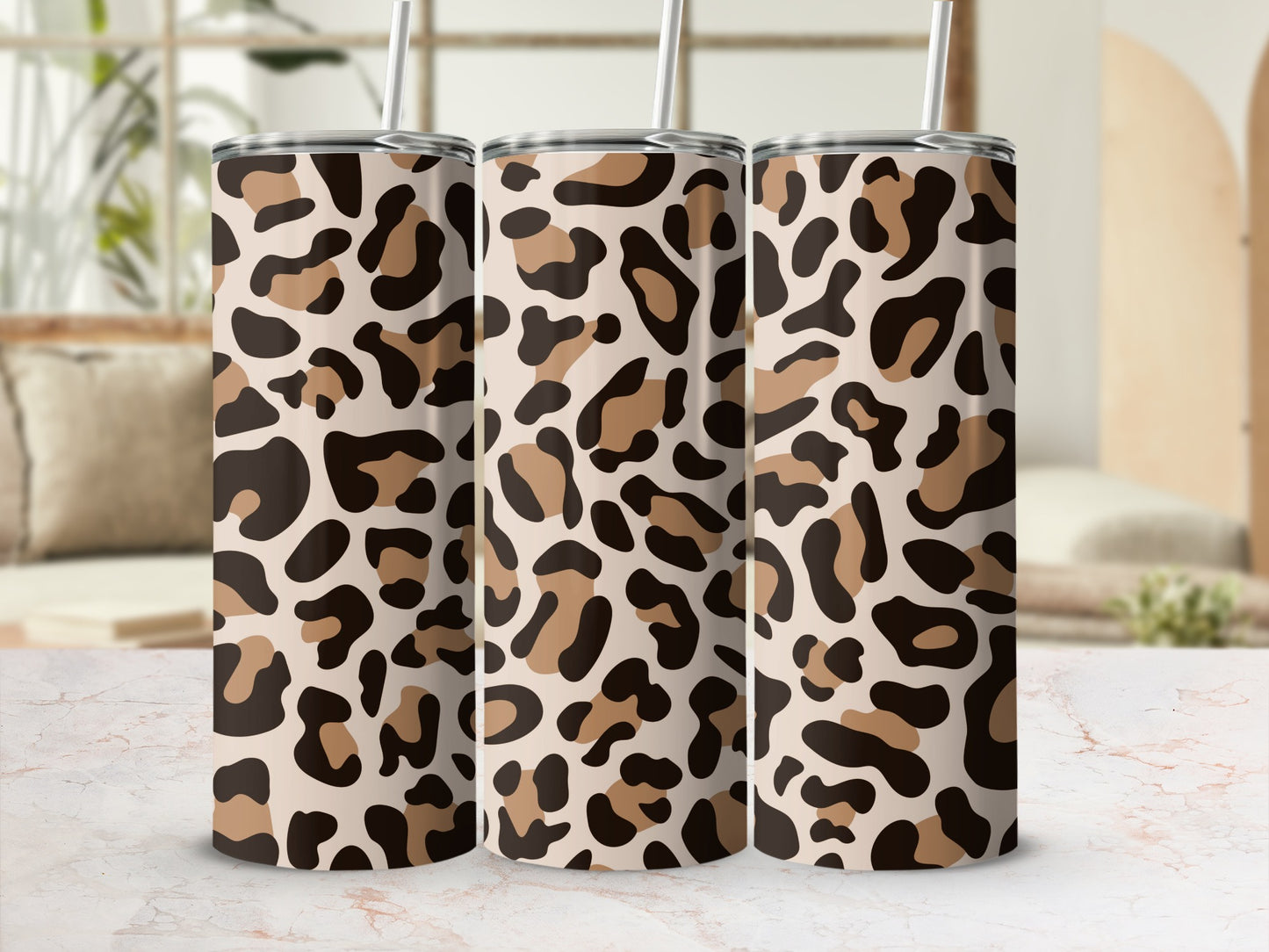 Three tumblers with a leopard print pattern, featuring straws.