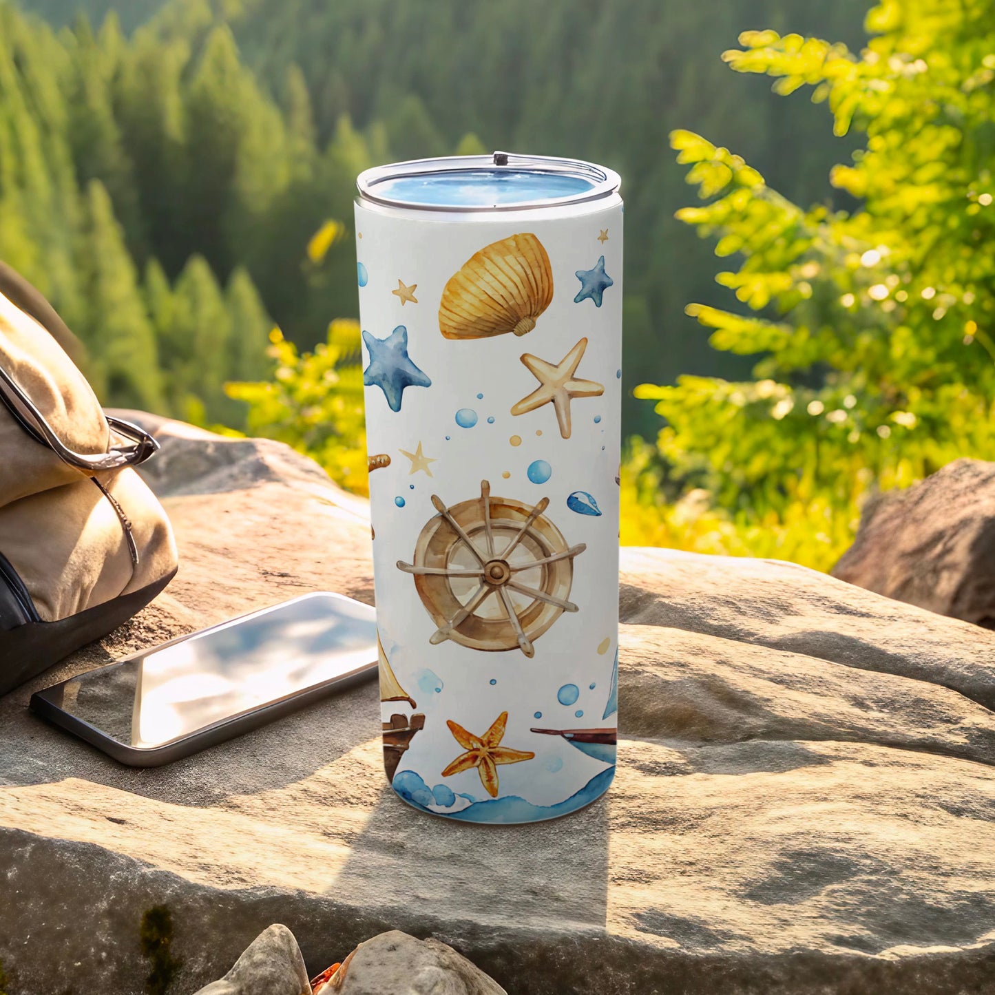 Nautical themed tumbler with seashells, starfish, and ship's wheel design.
