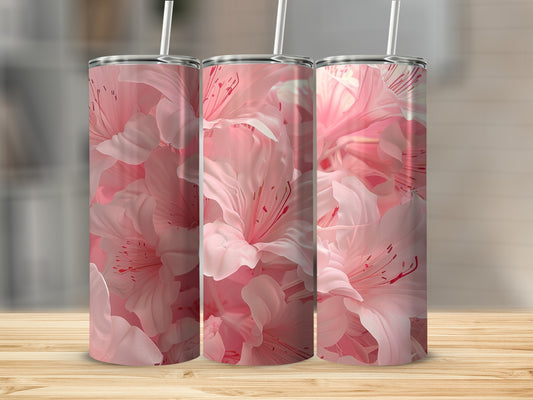 Three tumblers with pink floral patterns on a wooden surface.