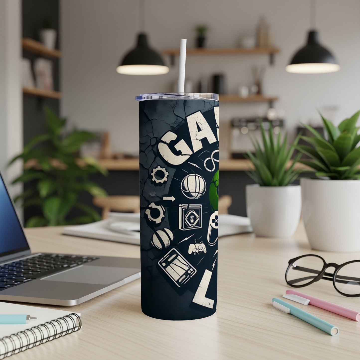 Black tumbler with gaming icons and "GAMING" text, on a desk.