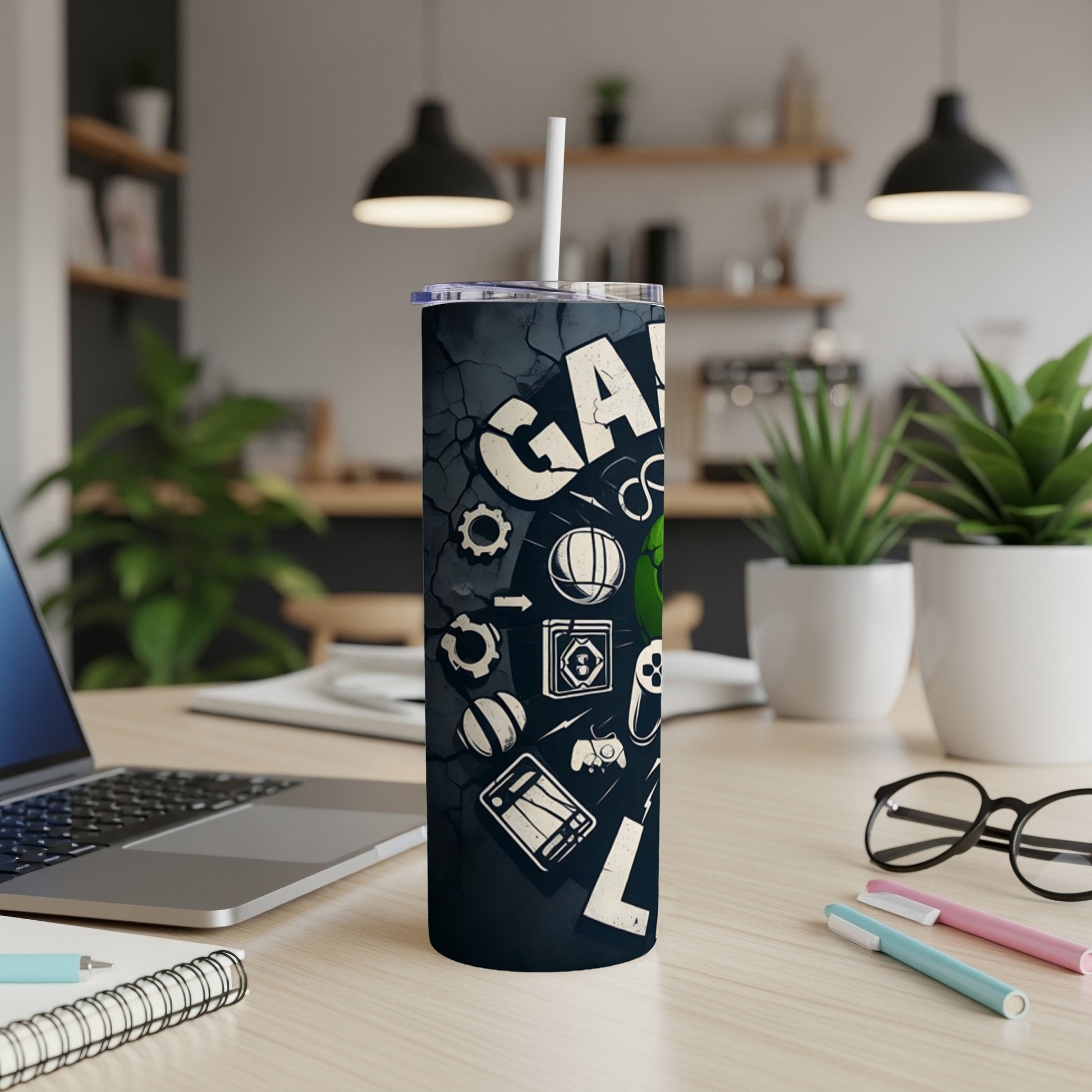 Black tumbler with gaming icons and "GAMING" text, on a desk.