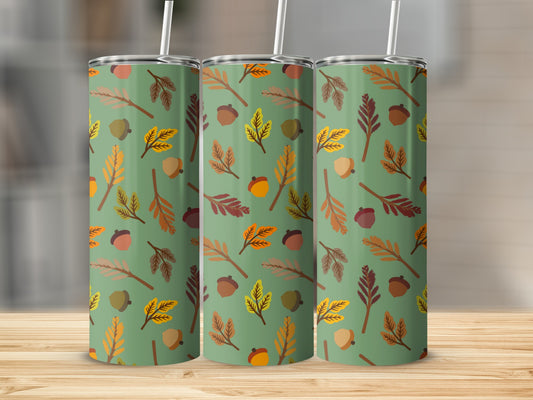 Green tumbler with repeating pattern of autumn leaves and acorns.