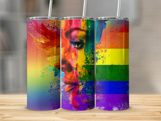 Tumbler with a vibrant rainbow flag and a person's face painted with rainbow colors.