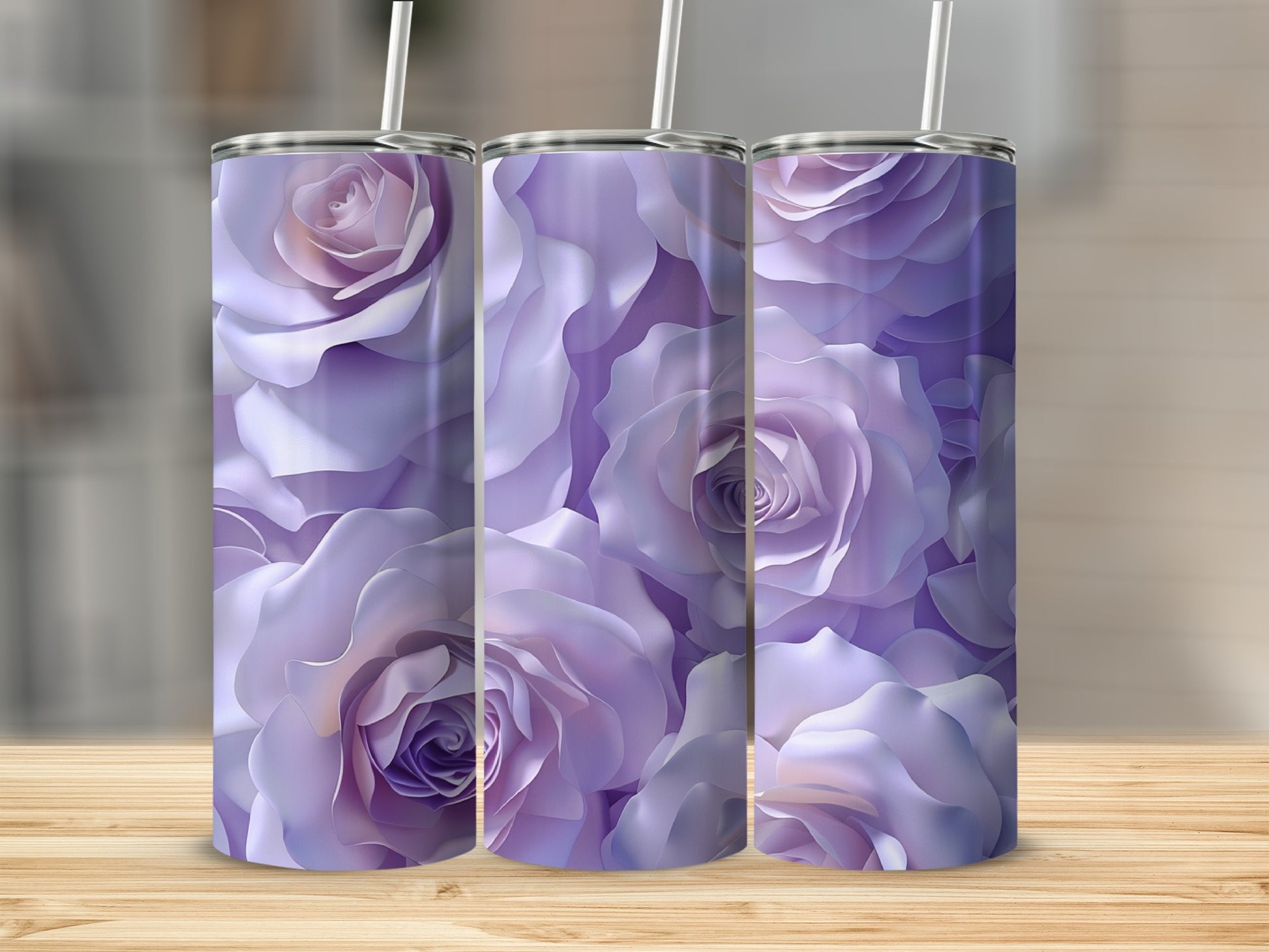 Three tumblers with a soft purple rose floral pattern on a wooden surface.
