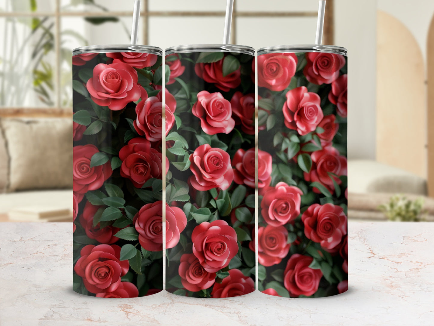 Three tumblers adorned with a repeating pattern of red roses and green leaves.