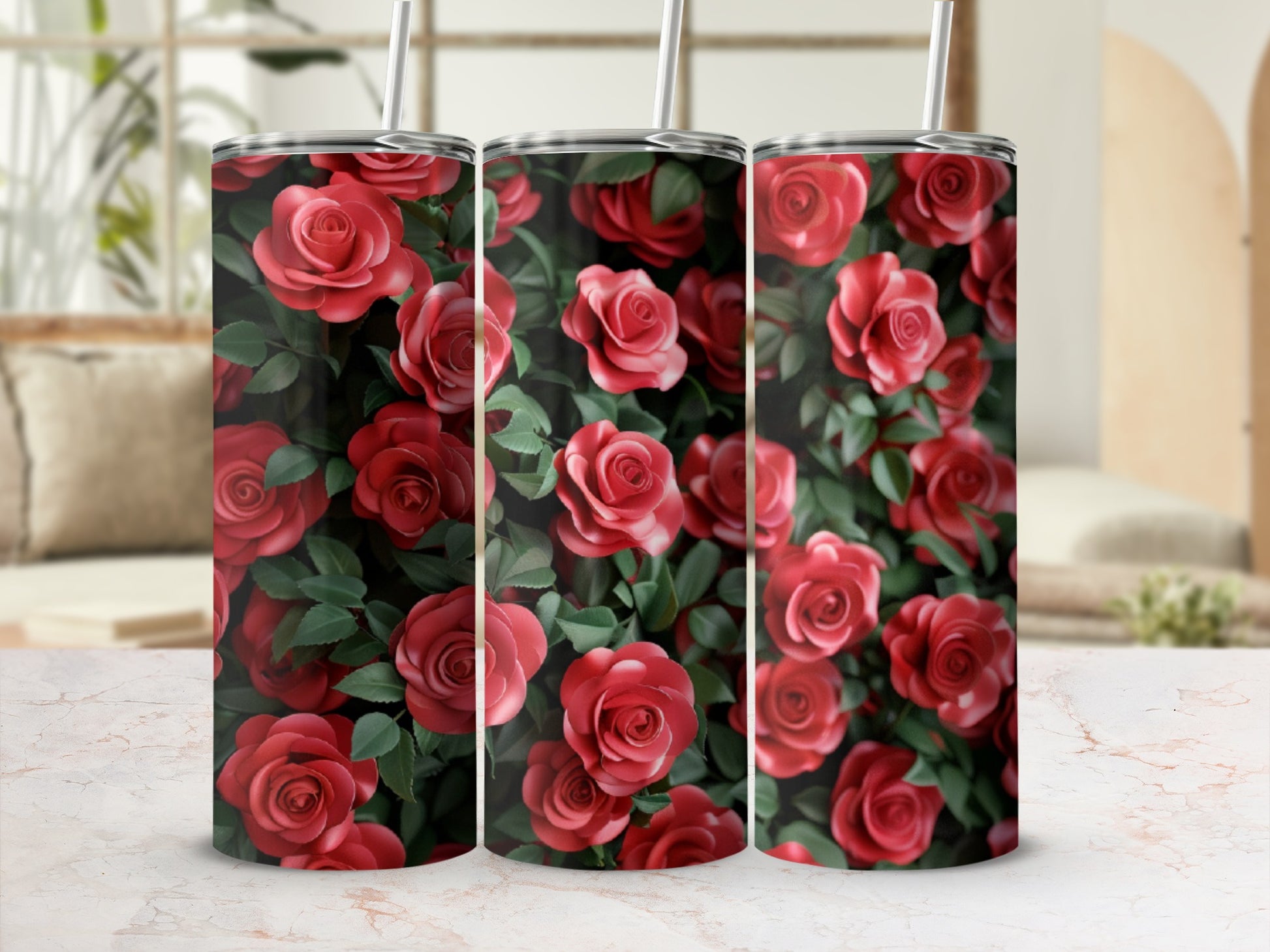 Three tumblers adorned with a repeating pattern of red roses and green leaves.