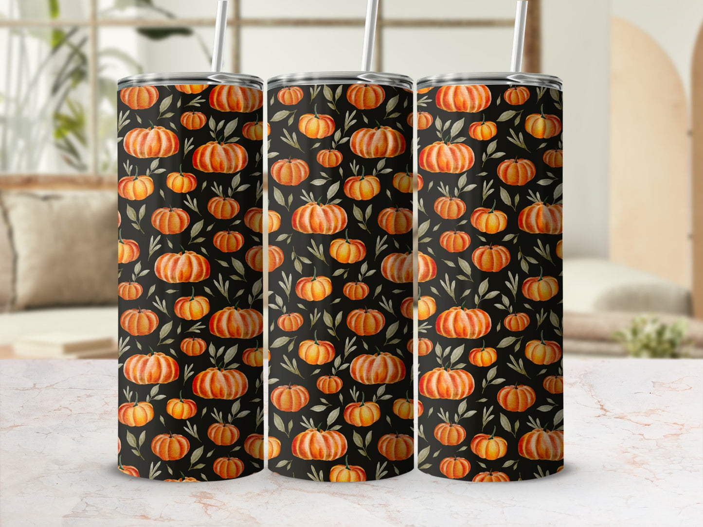 Three tumblers with a black background and orange pumpkin and green leaf pattern.