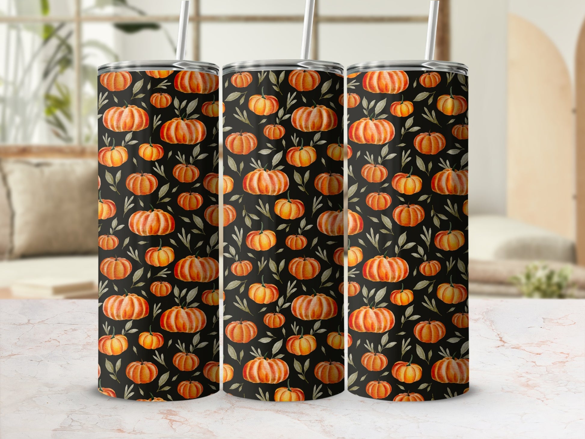 Three tumblers with a black background and orange pumpkin and green leaf pattern.