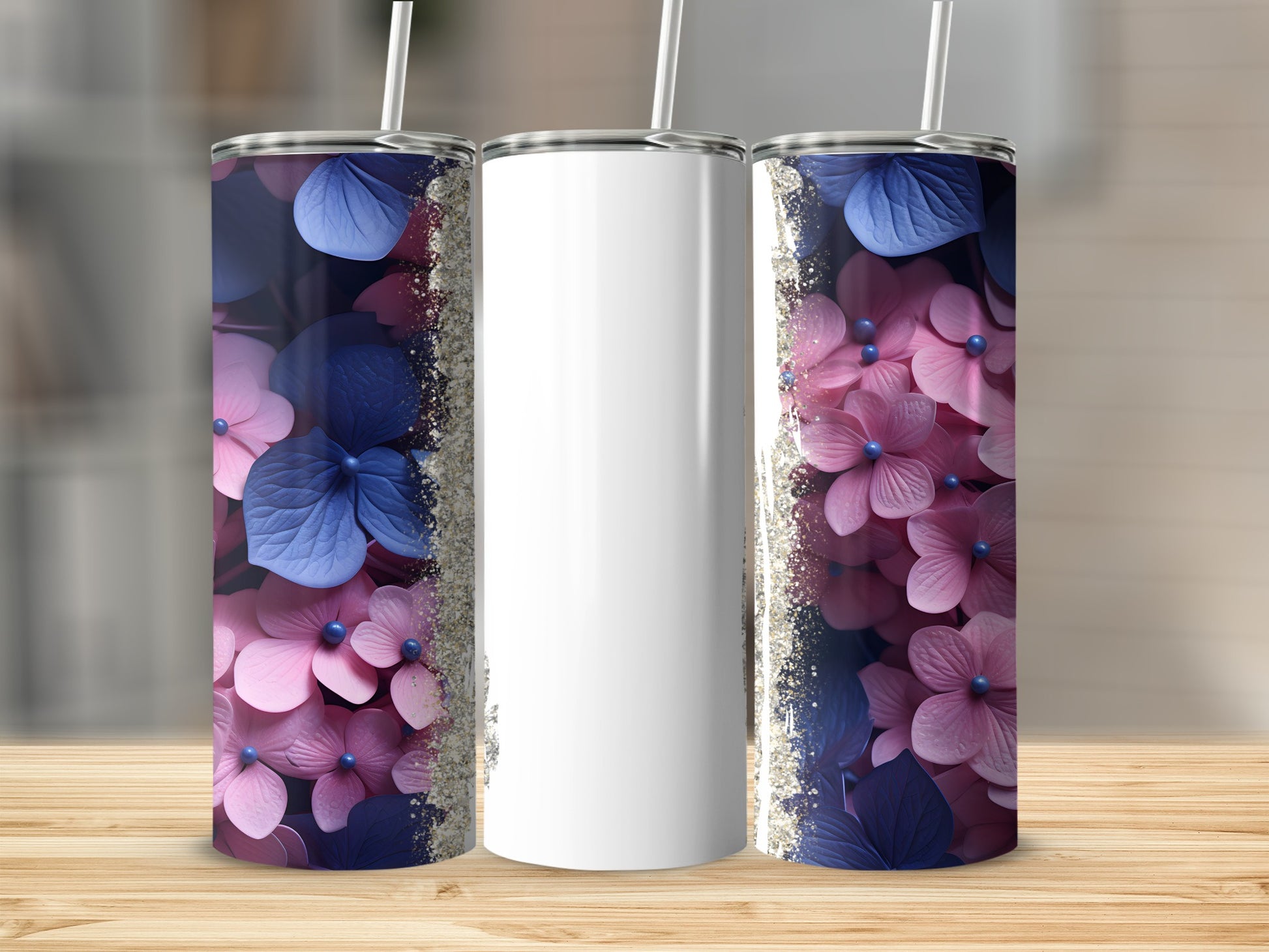 Three tumblers with pink and blue hydrangea floral designs and glitter accents.