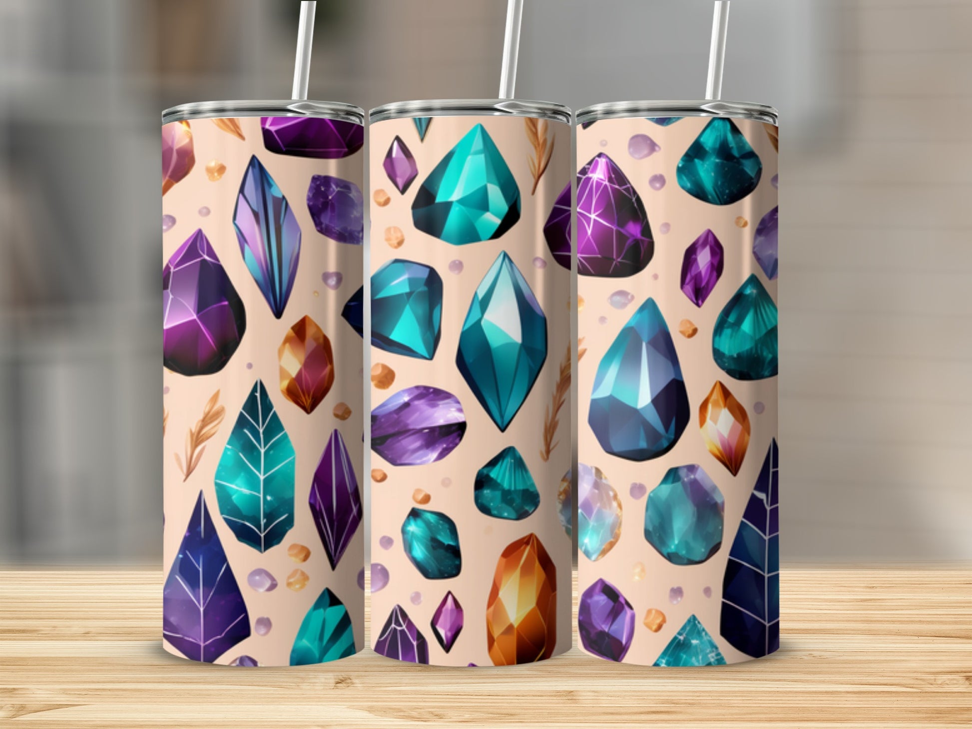 Three tumblers with a gemstone and feather pattern on a wooden surface.