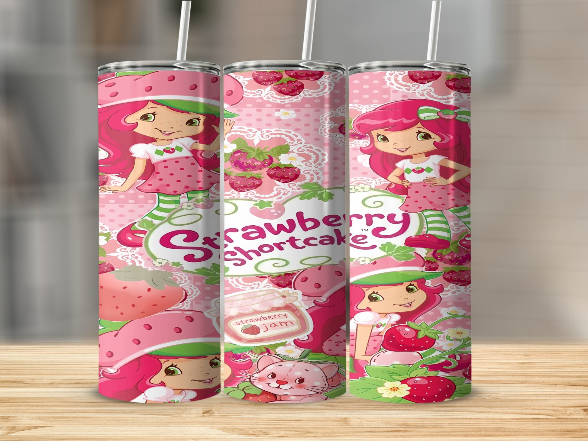 Strawberry Shortcake characters and jam jars on a pink patterned tumbler.