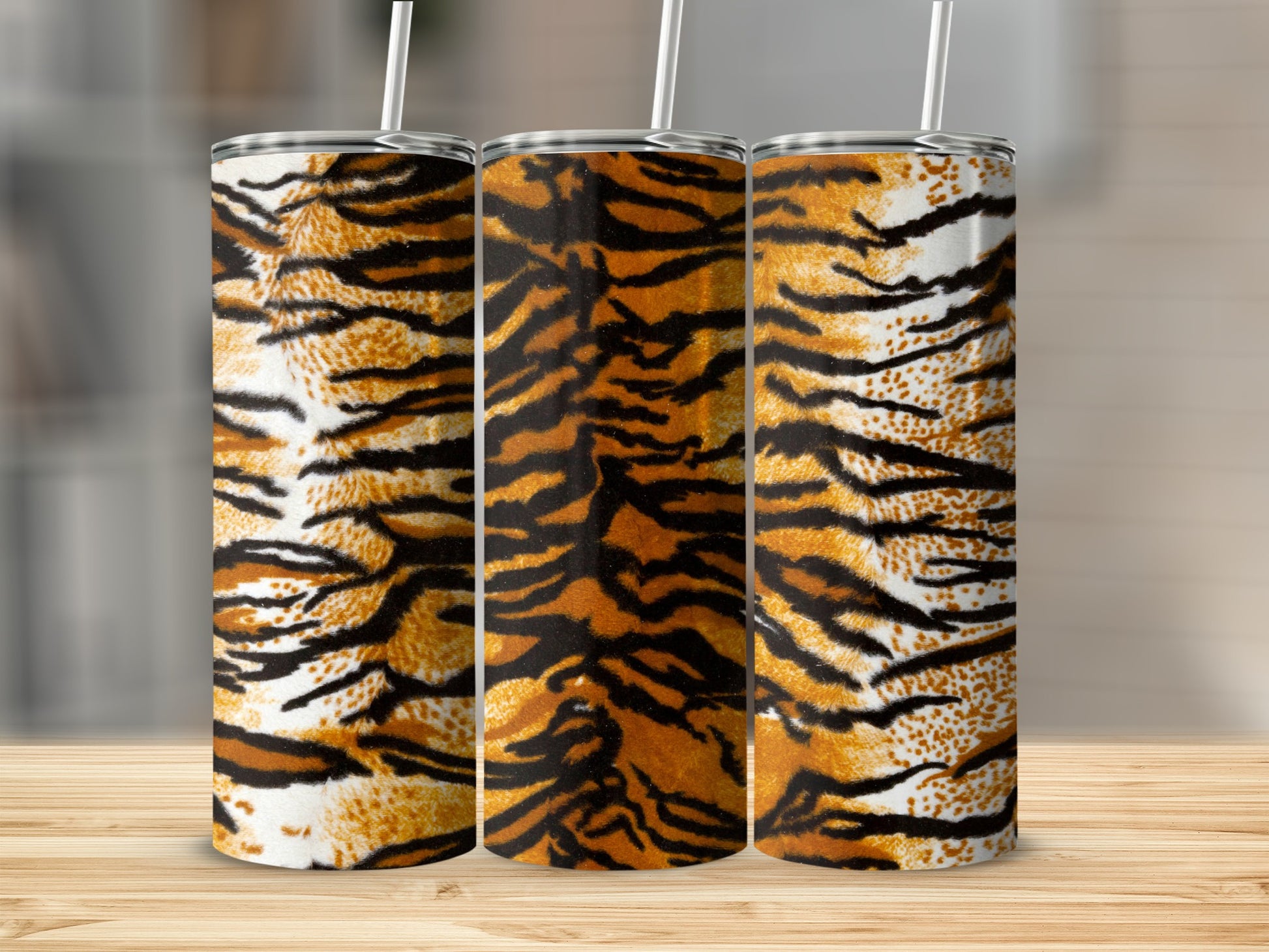 Three tumblers with tiger stripe pattern and white straws.