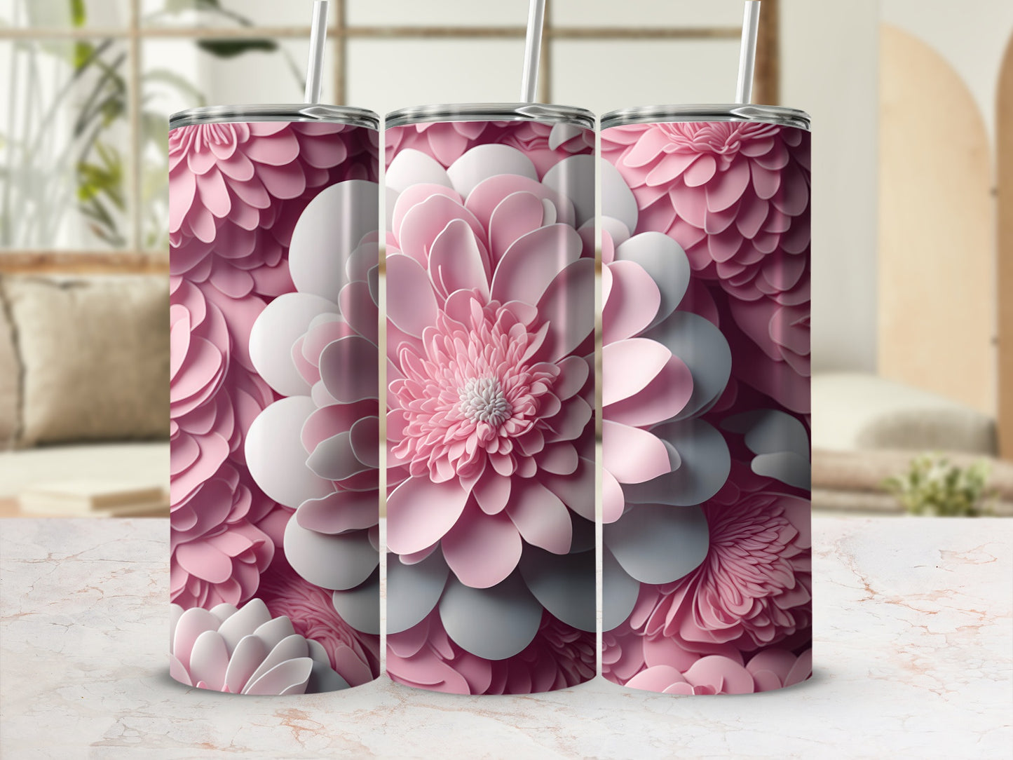 Three pink floral patterned tumblers with straws.