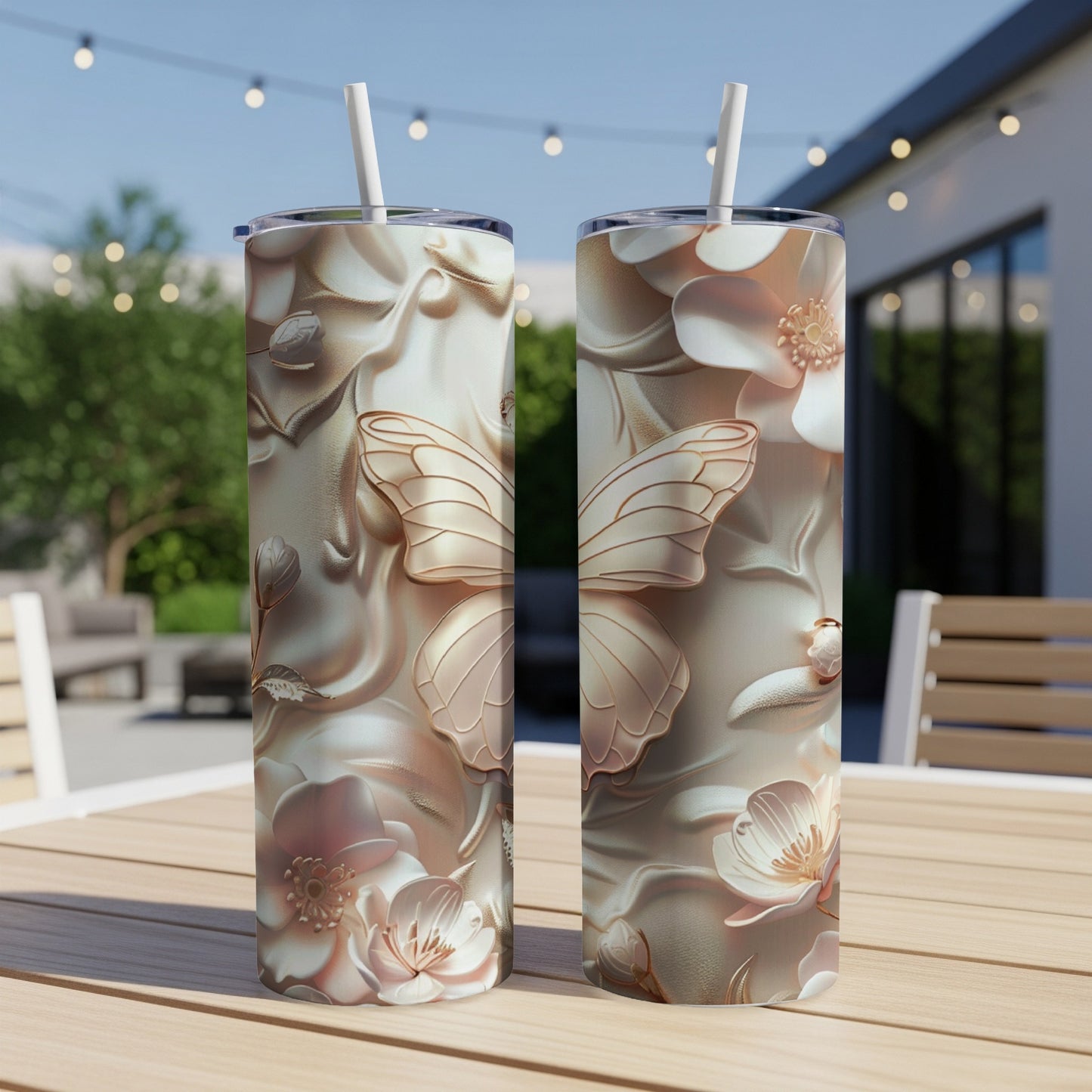 Two iridescent tumblers with floral and butterfly embossed designs.