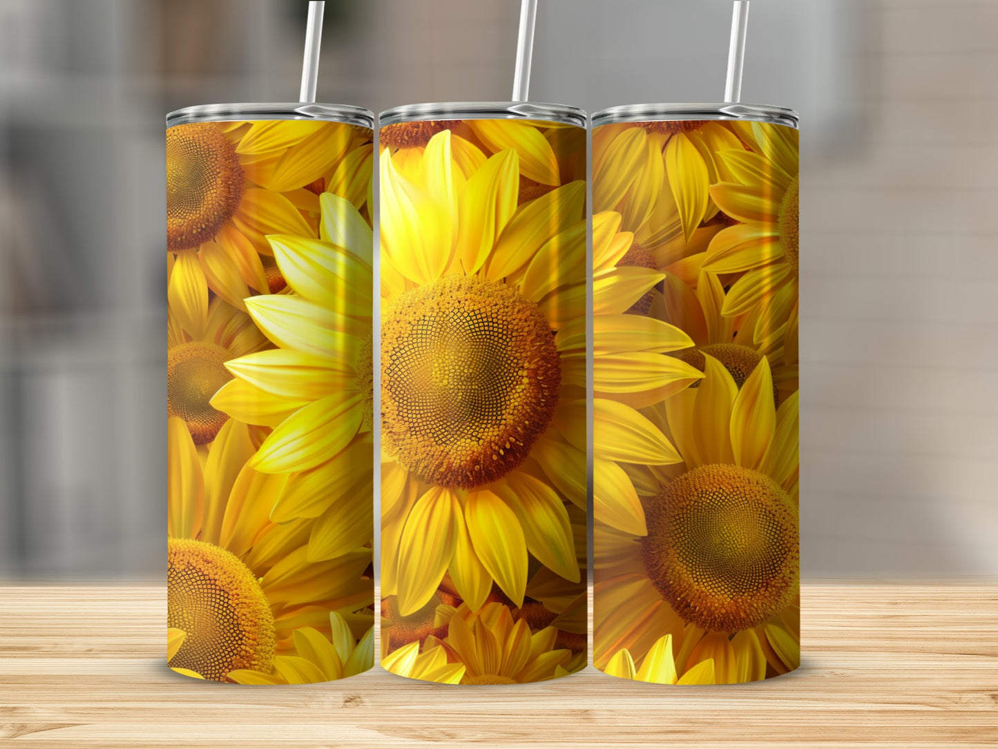 Three tumblers with a vibrant sunflower pattern on a wooden surface.