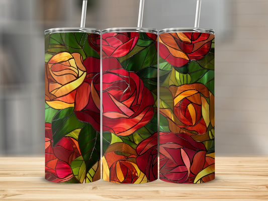 Three tumblers with stained glass rose design on a wooden surface.