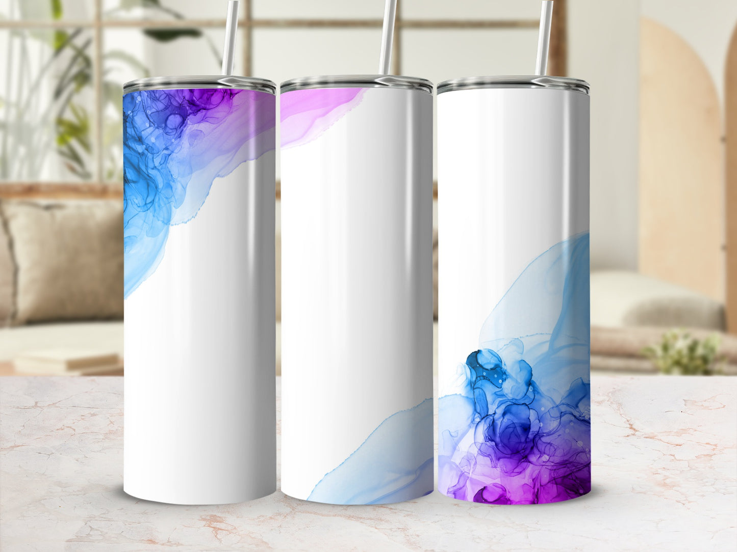 Three white tumblers with blue and purple watercolor designs.