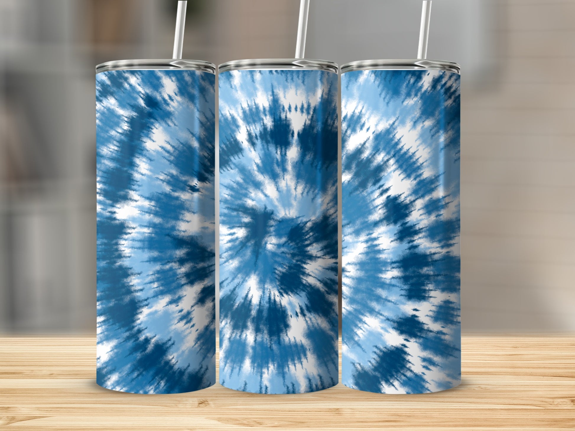 Three tumblers with blue and white tie-dye pattern and straws.