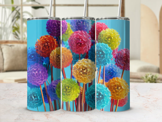 Three colorful tumblers with dandelion designs and straws.