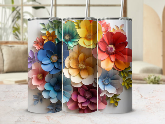 Three tumblers adorned with colorful floral designs in a cluster.