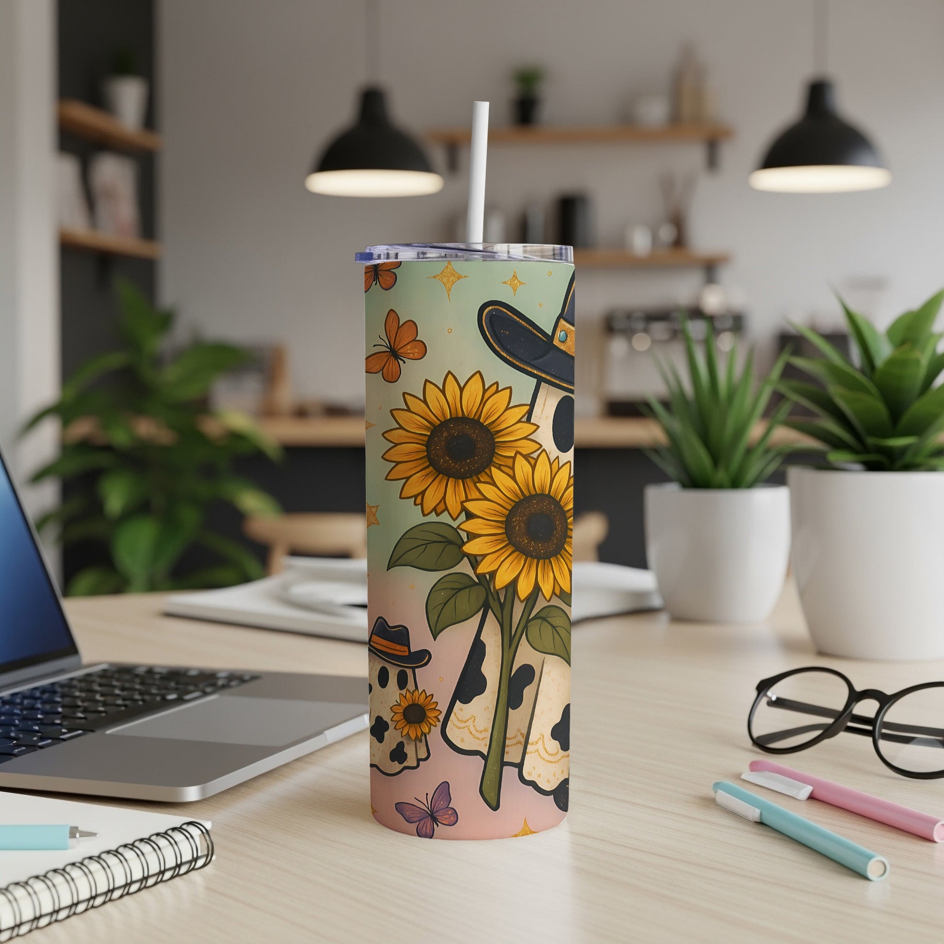 Tumbler with sunflowers, ghosts wearing hats, and butterflies on a pastel background.