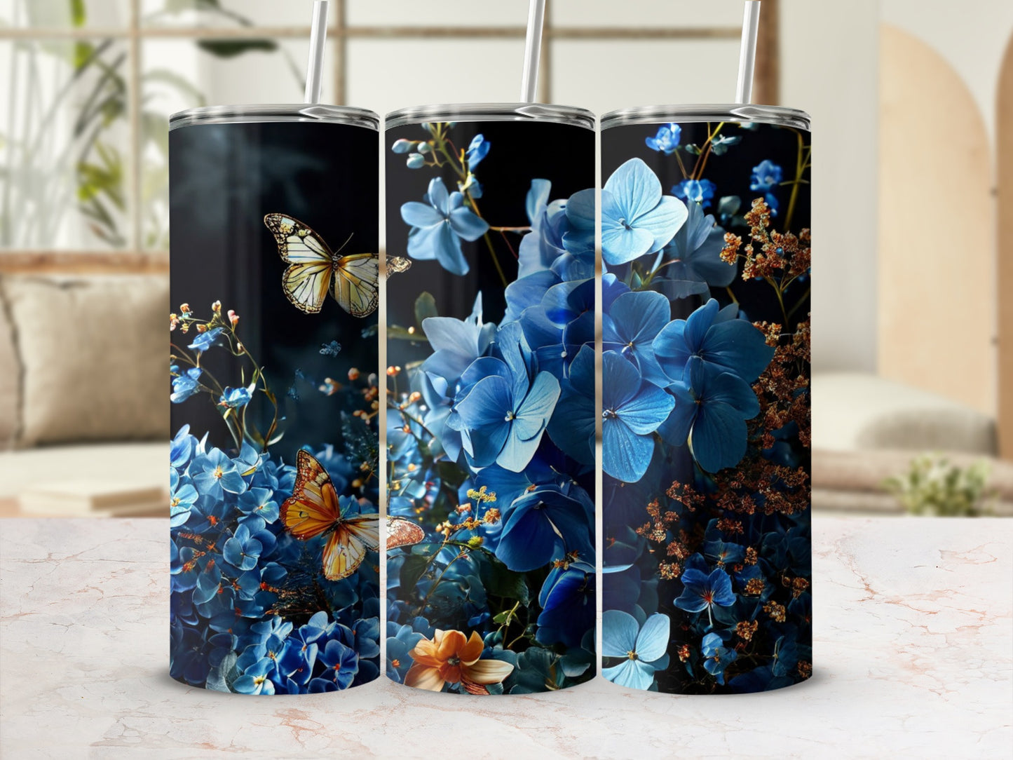 Three tumblers featuring blue hydrangeas and butterflies, with a soft background.