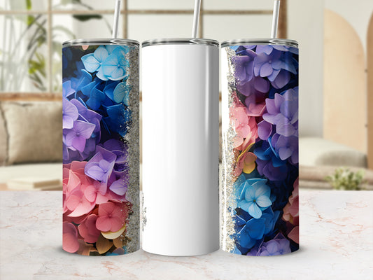 Two tumblers with floral designs, one blank white, on a marble surface.