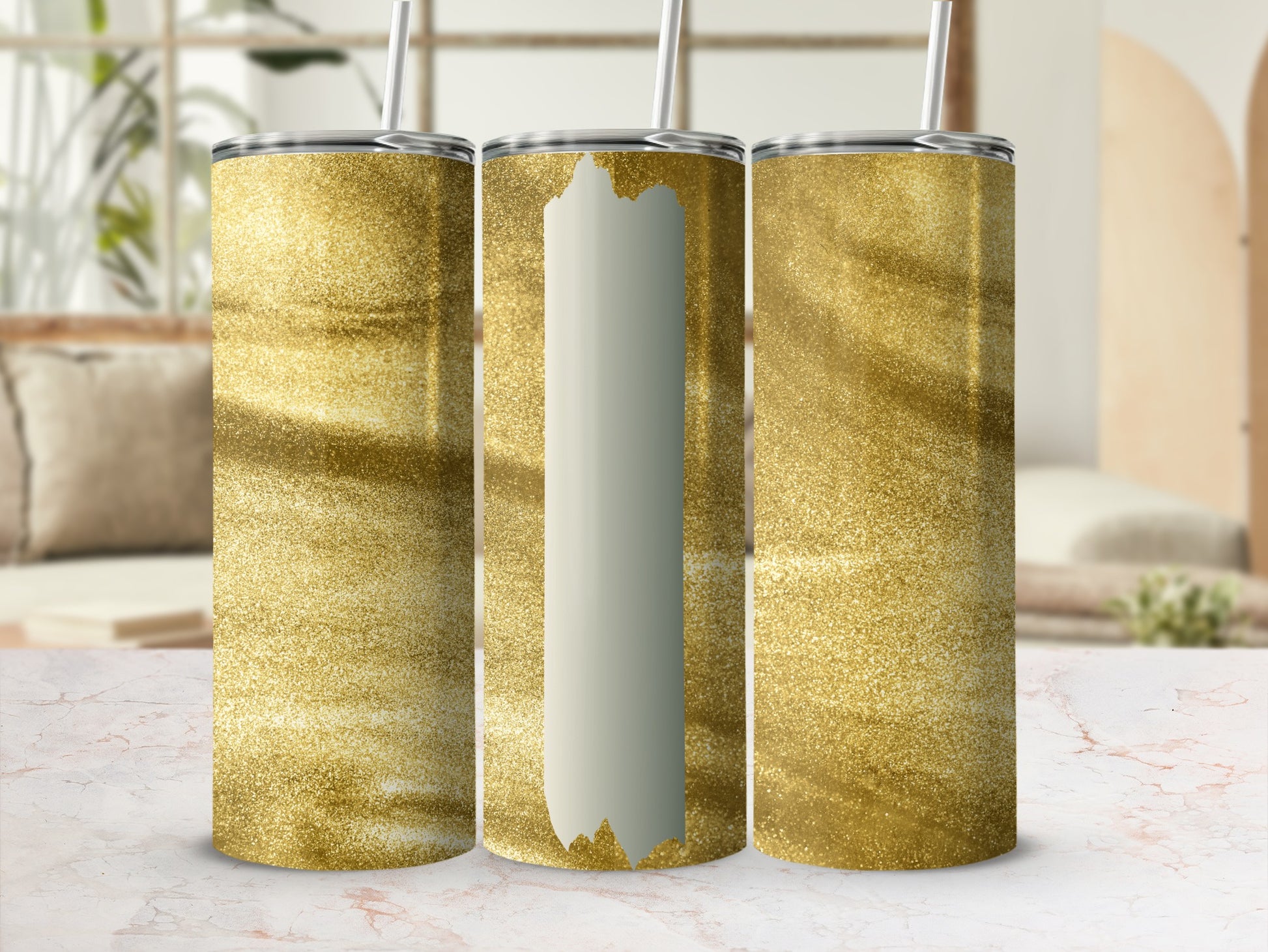 Three gold glitter tumblers with straws, one blank.
