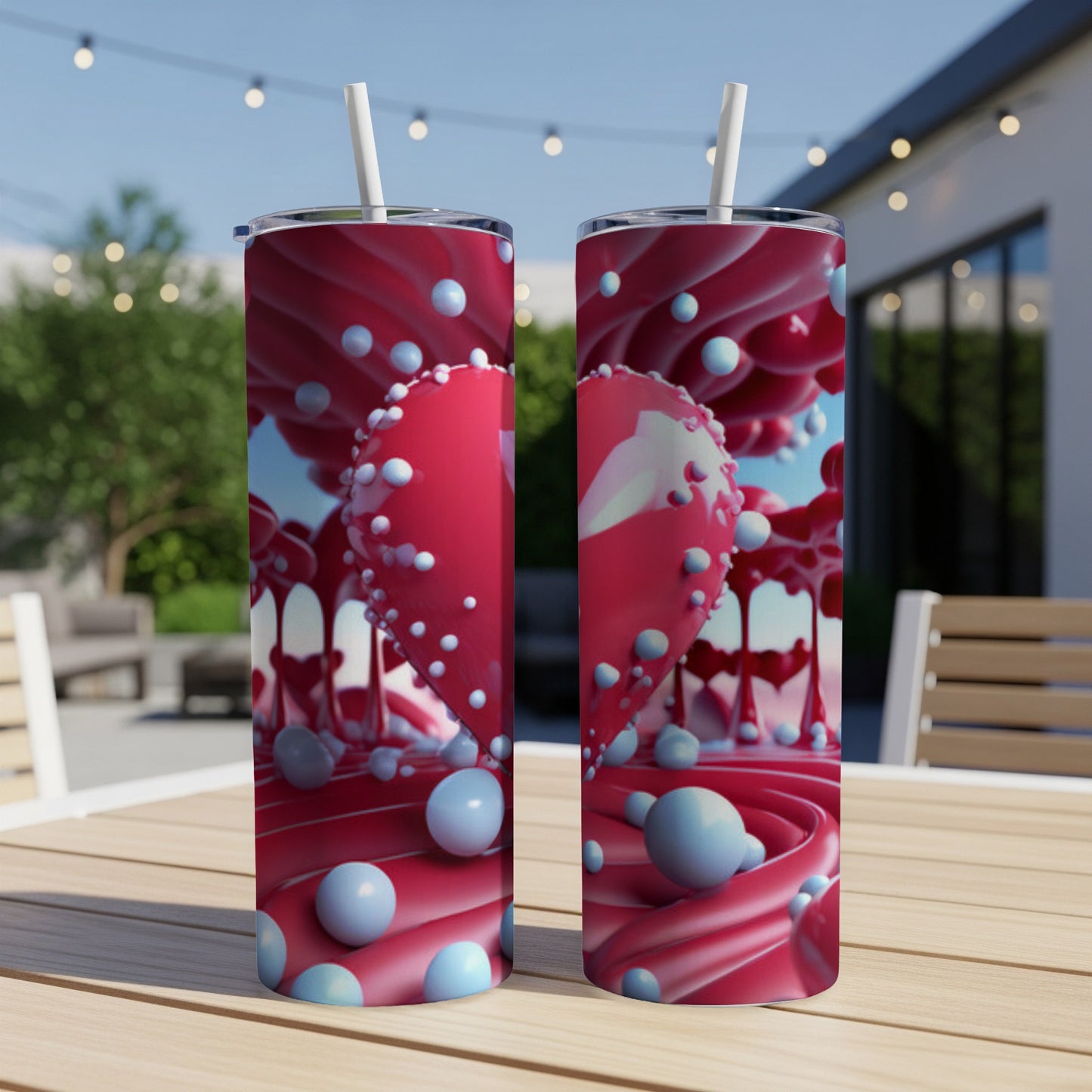 Two tall tumblers with red heart and pink swirl design, outdoors.