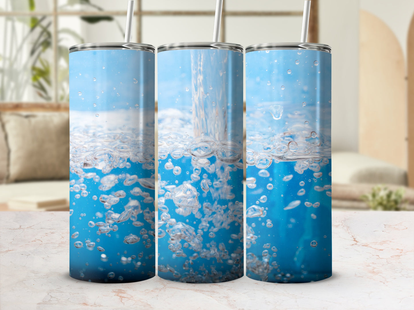 Three tumblers with water splash and bubbles on a marble countertop.