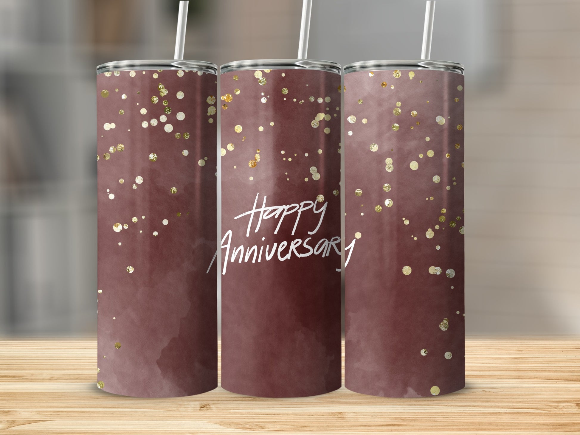 Maroon tumbler with gold glitter and "Happy Anniversary" text.