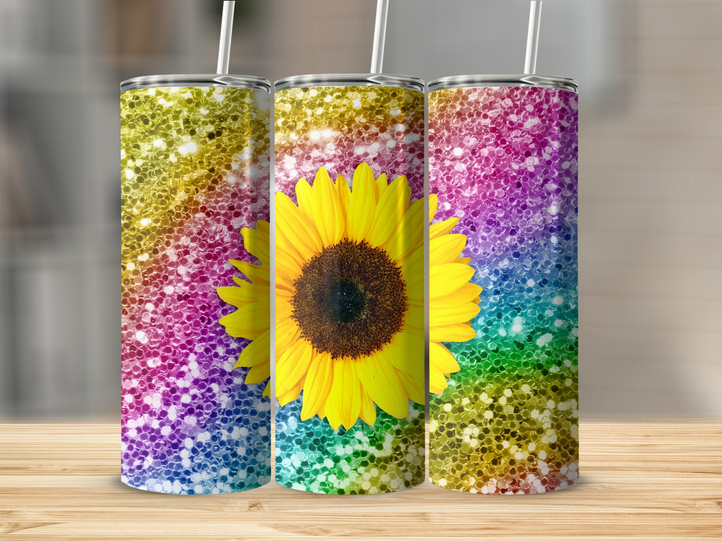 Three tumblers with sunflower and rainbow glitter designs.