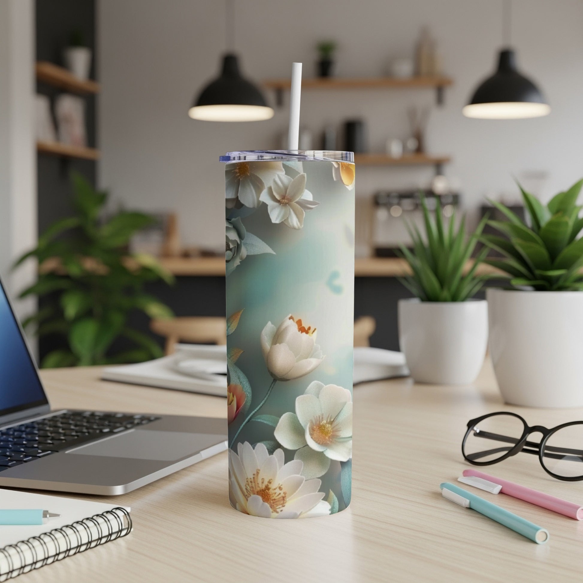 White floral pattern on a tall, insulated tumbler with a straw.