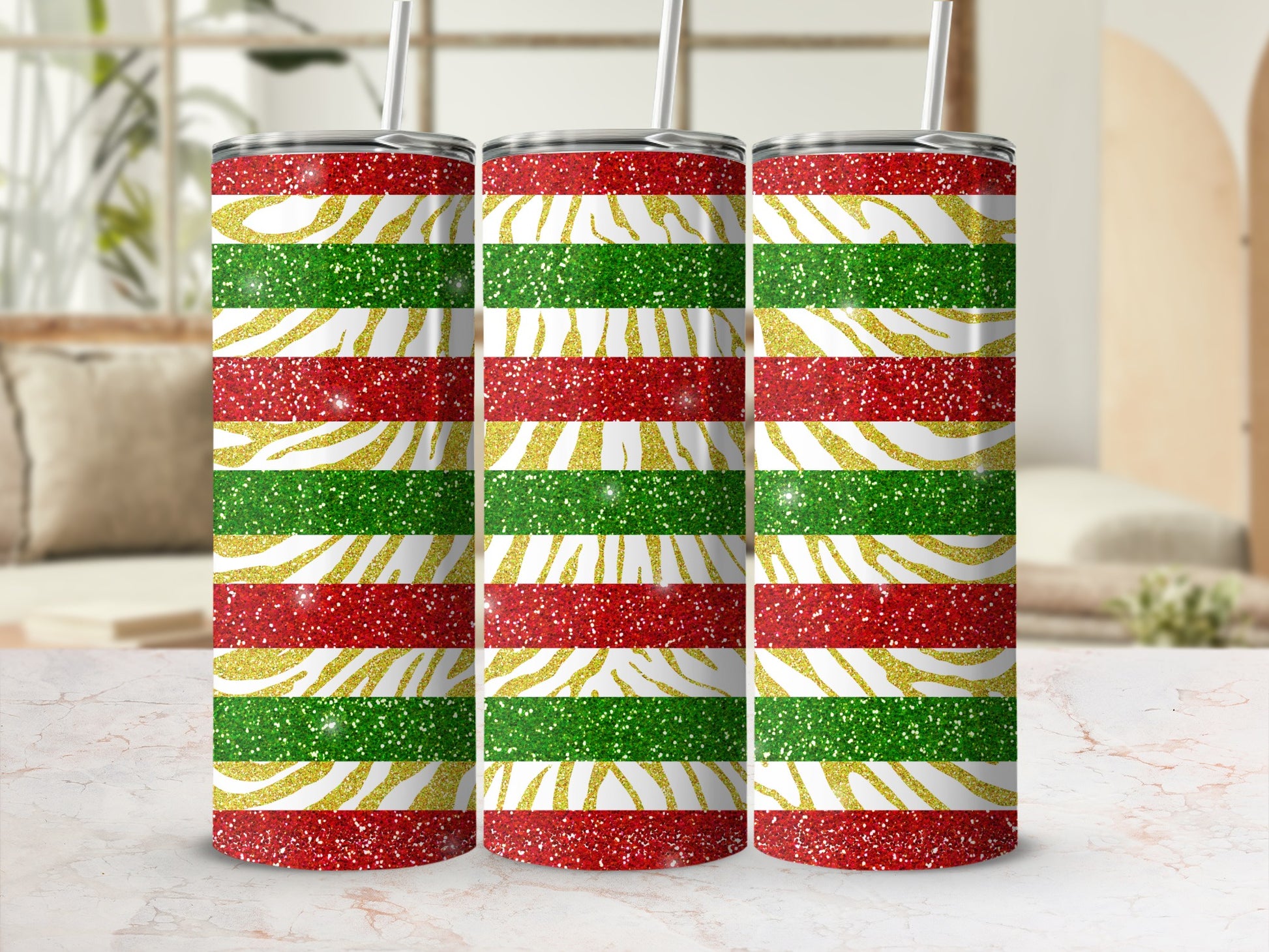 Three glitter-covered tumblers with red, green, and gold horizontal stripes.