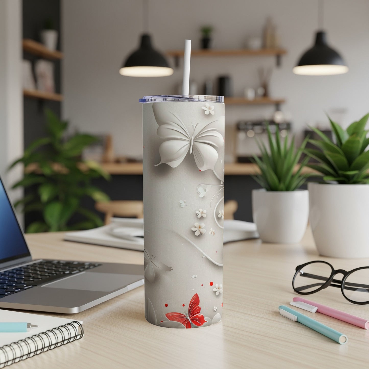 White tumbler with red and white butterflies and floral designs.