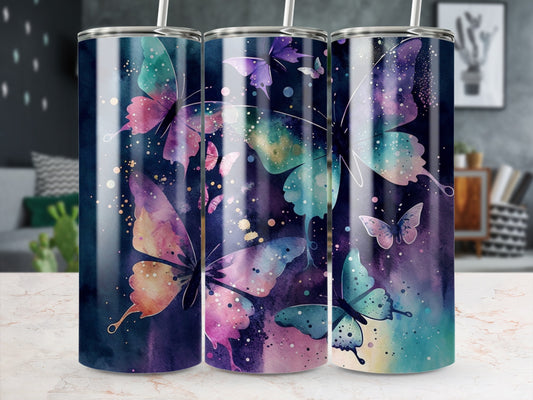Three tumblers with watercolor butterfly designs on a marble surface.