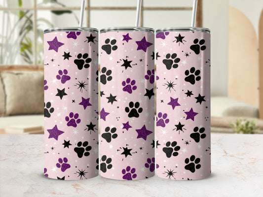 Pink tumbler with purple stars and paw prints.