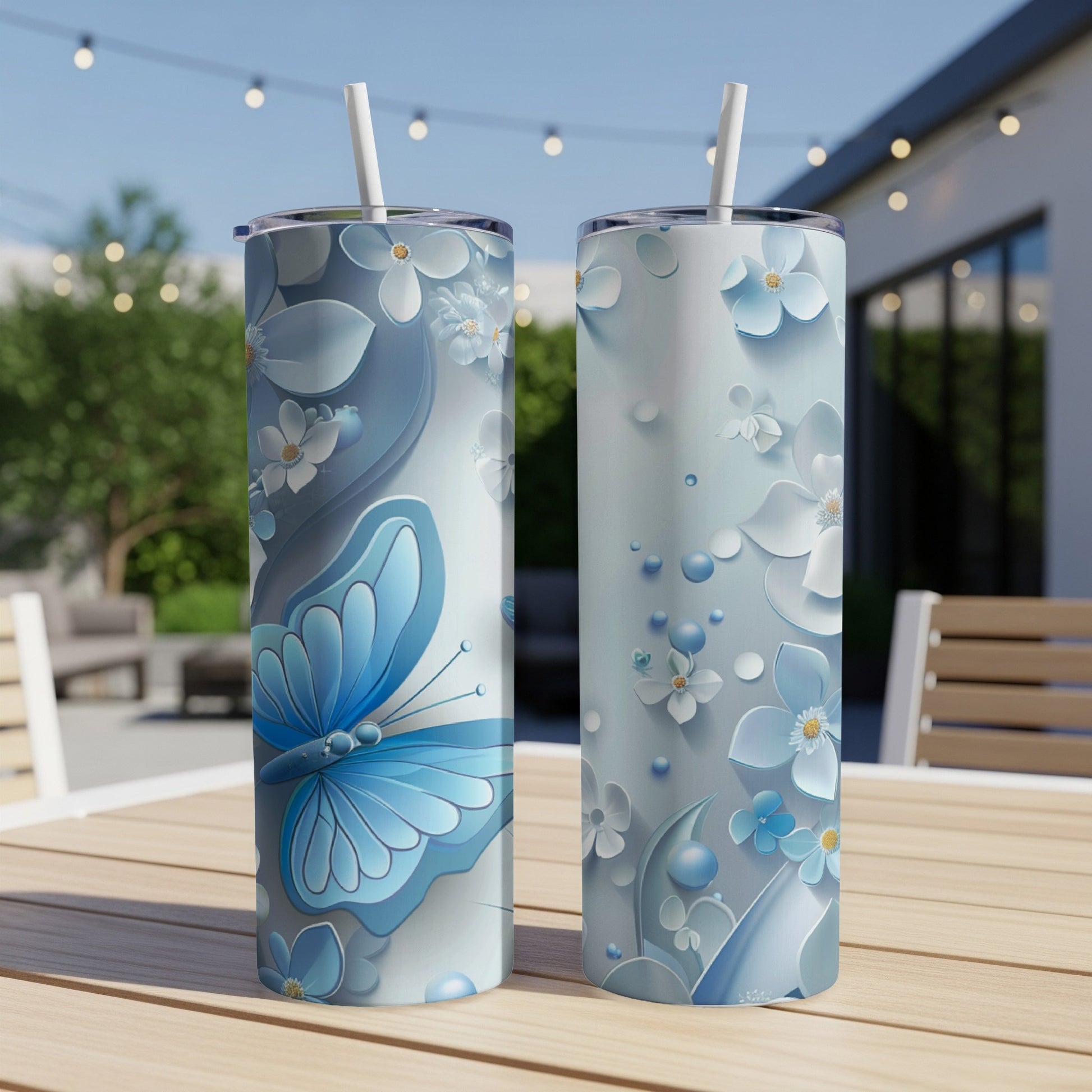 Two tall tumblers with a blue butterfly and floral design.