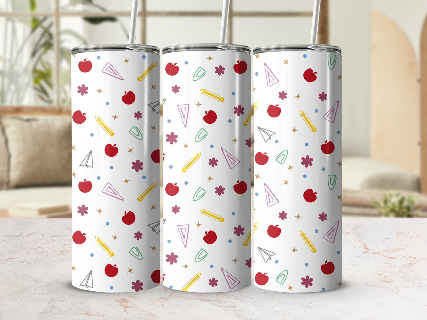 Three white tumblers with school-themed icons: apples, pencils, paper airplanes, and stars.