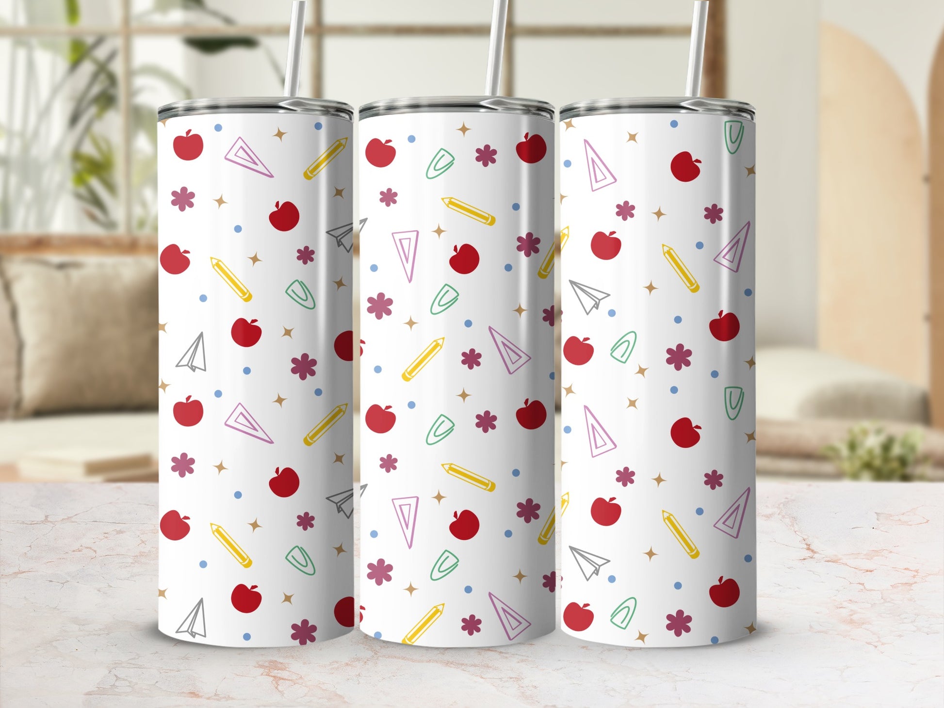 Three white tumblers with school-themed icons: apples, pencils, paper airplanes, and stars.