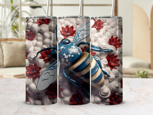 Bee design on a white tumbler with red flowers and blue accents.