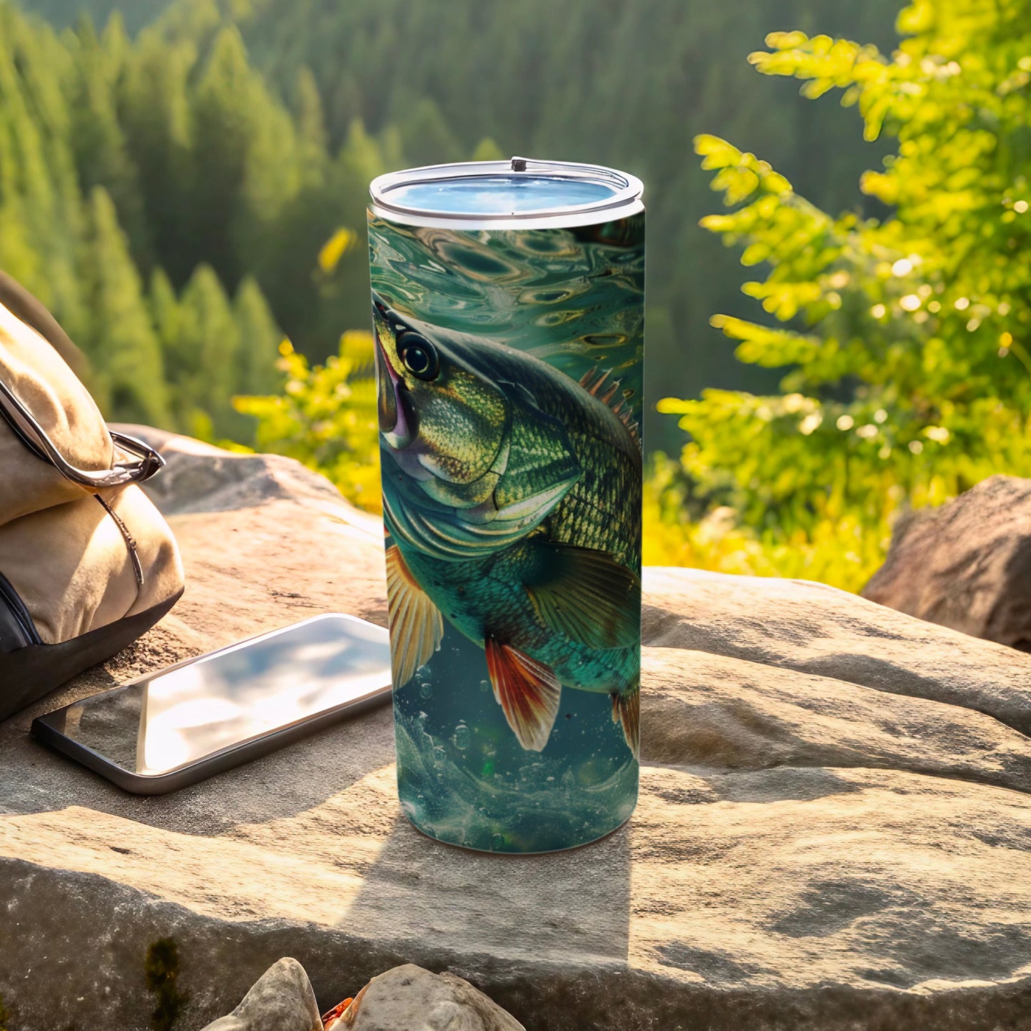 Black bass swimming underwater on a travel tumbler with phone and bag.