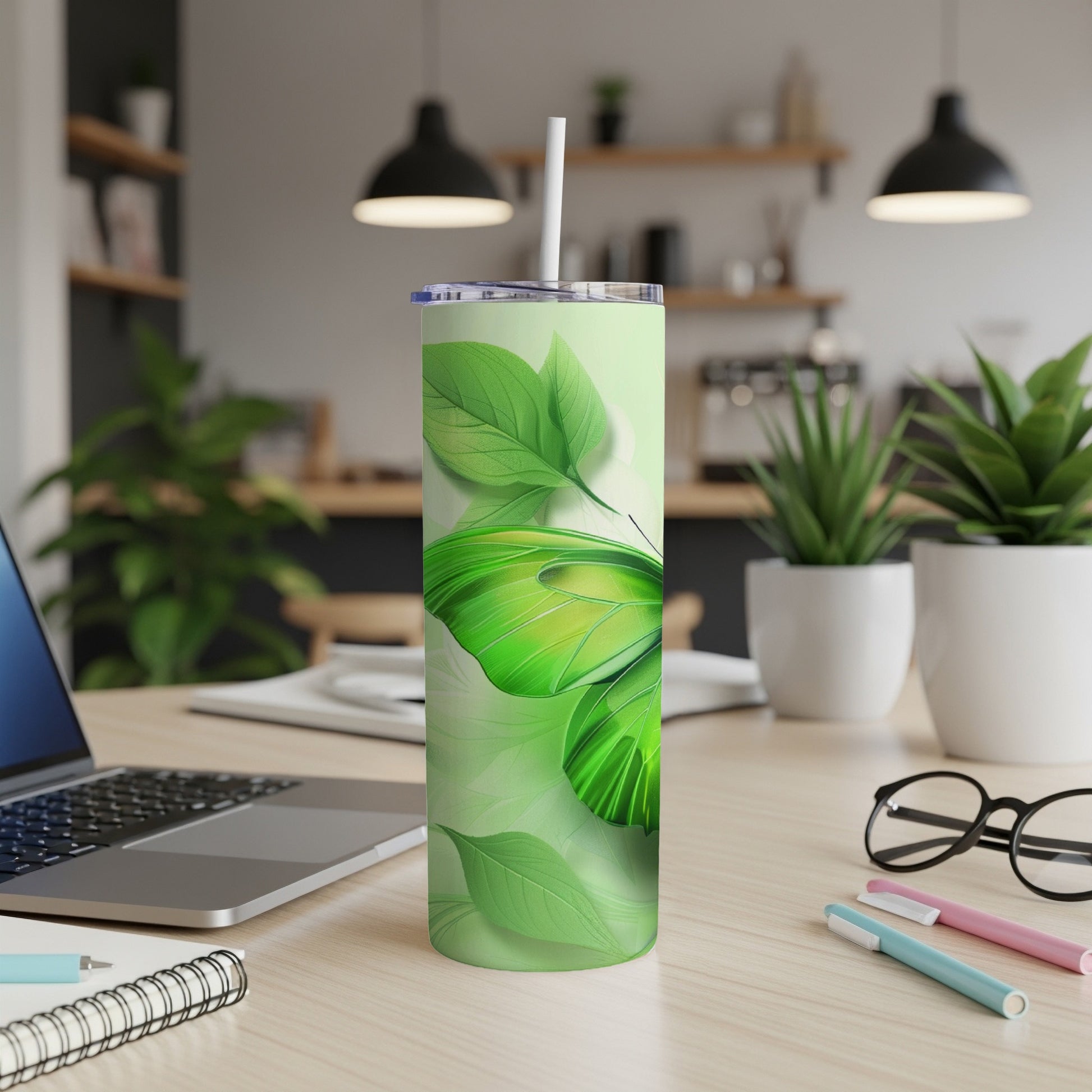 Green butterfly and leaves pattern on a white skinny tumbler with straw.