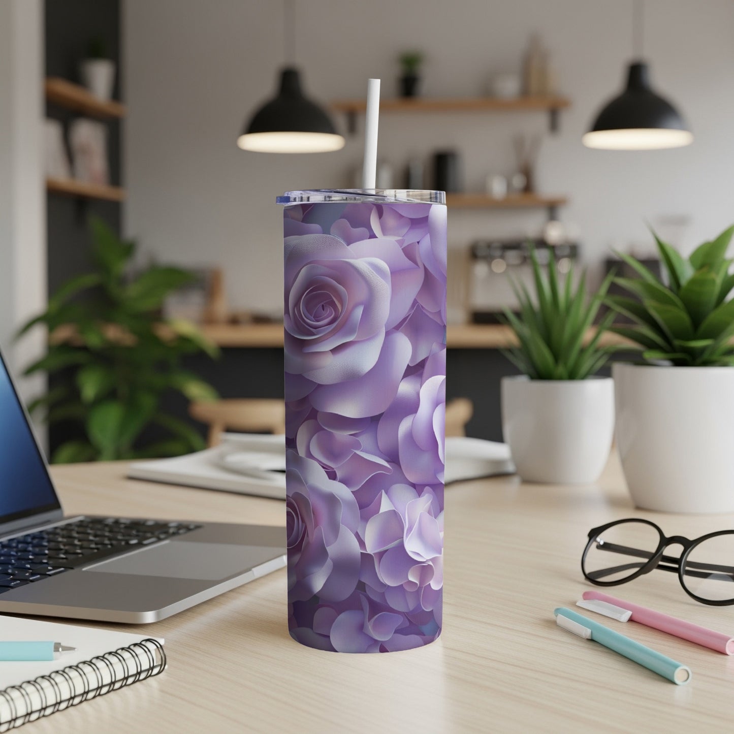 Purple rose pattern tumbler with straw on a desk.